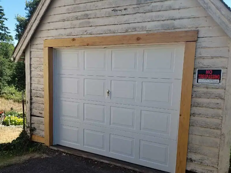 After: white raised-panel garage door
