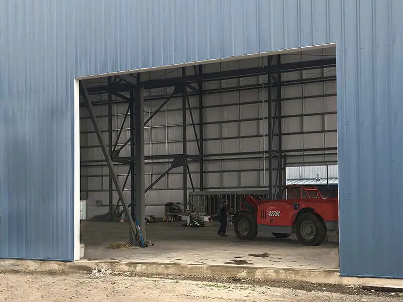 Before: commercial building with an open door bay