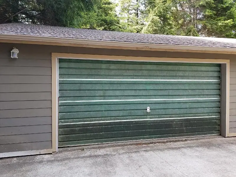 Before: worn green garage door