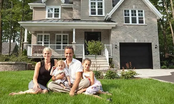 Family in front of their home and garage
