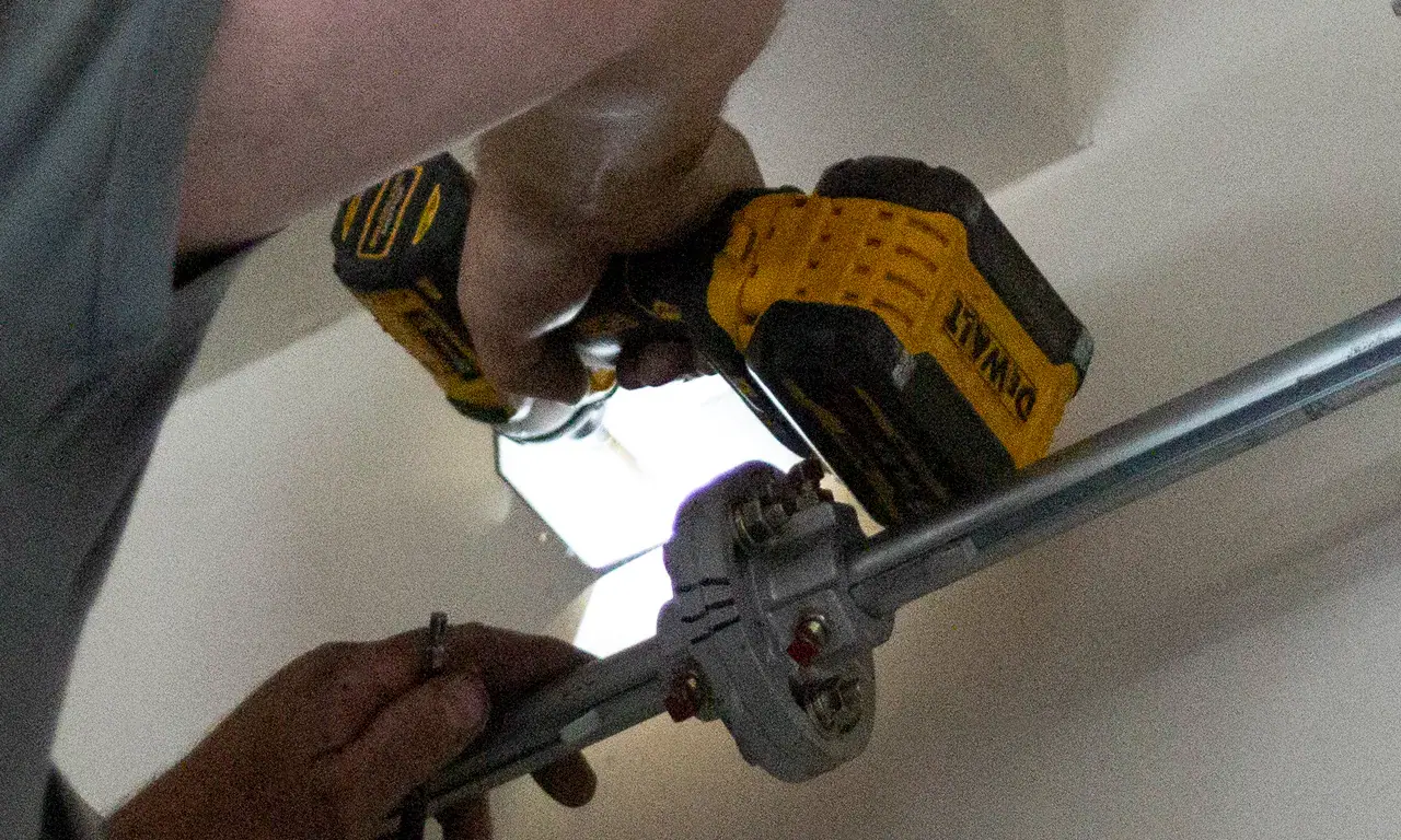 Technician installing a garage door opener