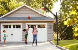 Family playing near a garage