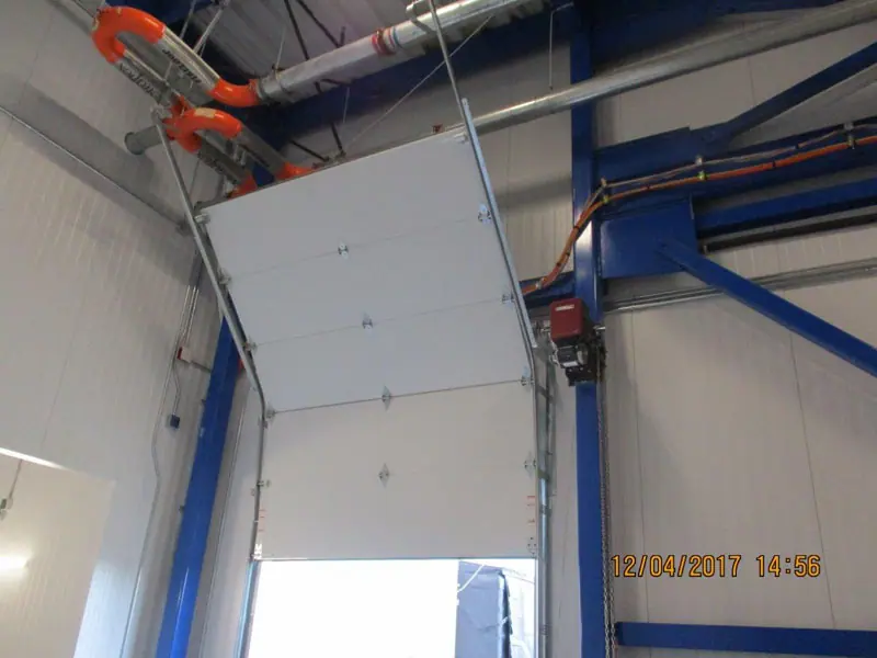 Industrial sectional door being installed